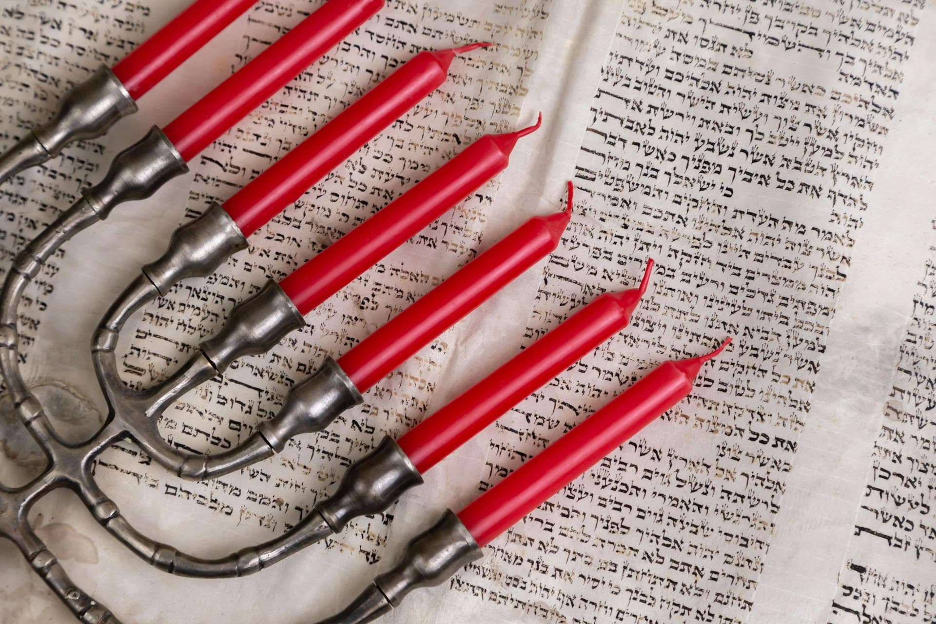 A multibranched candelabra on a book with Jewish scripture